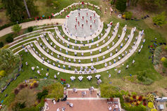 Aerial view of IU Marching Hundred band members performing with cheerleaders on campus.